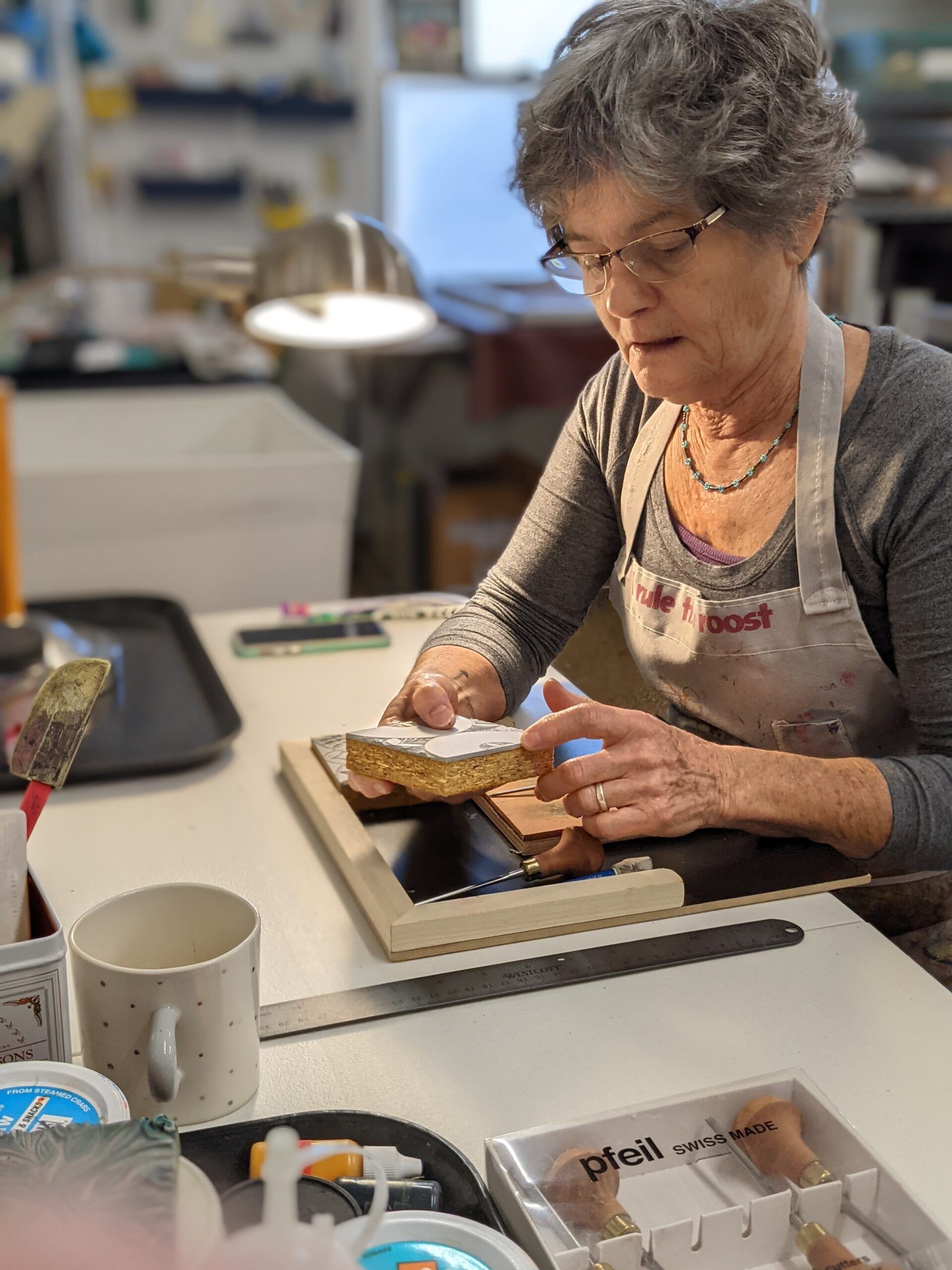 Jeanne Brady, in her private studio, detailing printing on fabric. 